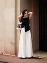 A woman wears a pair of white pants